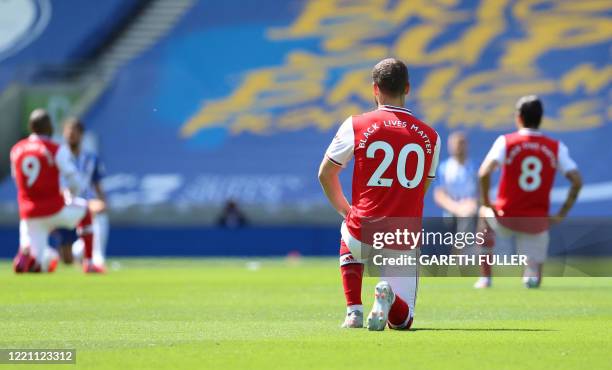 Arsenal's German defender Shkodran Mustafi takes a knee to show support for the Black Lives Matter movement and as a protest against racism before...