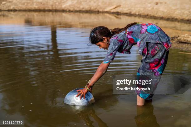 indian young girl collecting potable water from the lake, desert village, india - carrying water stock pictures, royalty-free photos & images