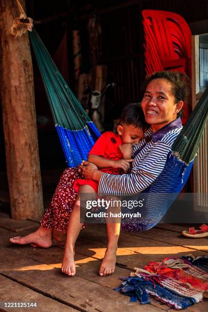 cambodian mother with her son lie on the hammock, cambodia - cambodian ethnicity stock pictures, royalty-free photos & images