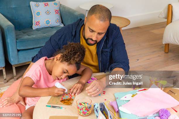 young girl and her father doing arts and crafts - melbourne lockdown stock pictures, royalty-free photos & images