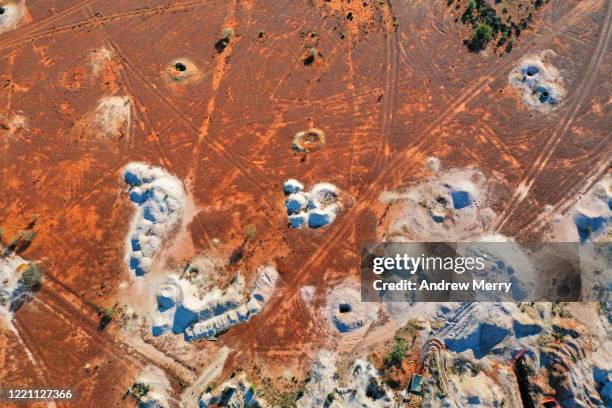 desert landscape with mineshaft holes, white dirt mine tailings on red earth, white cliffs, australia - opal stock pictures, royalty-free photos & images