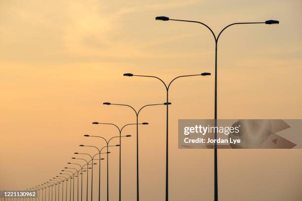 low angle view of street lights - led street lighting stock-fotos und bilder