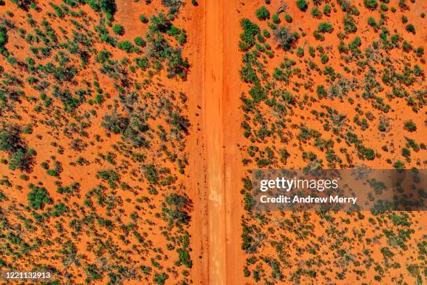 outback red dirt road and trees, australia, aerial view - orange new south wales stock pictures, royalty-free photos & images