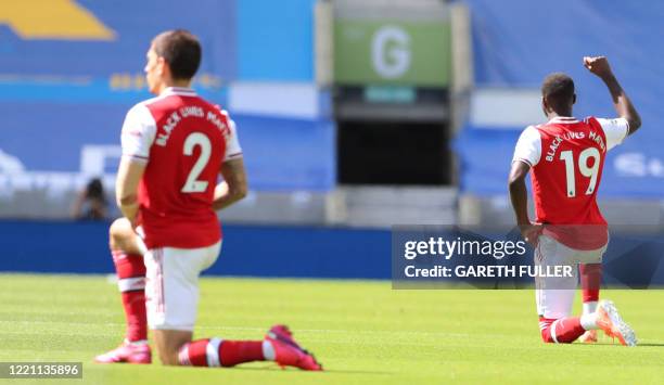 Arsenal's French-born Ivorian midfielder Nicolas Pepe takes a knee to show support for the Black Lives Matter movement and as a protest against...