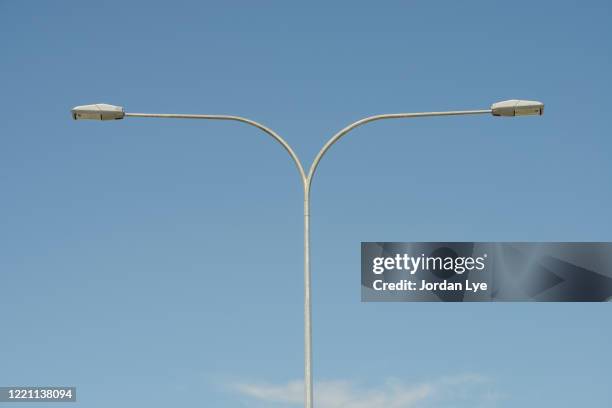 street lights against clear blue sky - led street lighting stockfoto's en -beelden