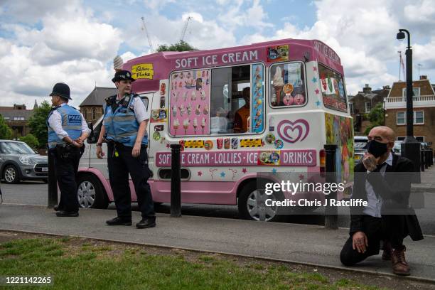 Protester takes a knee in front of an ice cream van during a Black Lives Matter demonstration on June 20, 2020 in London, United Kingdom. Black Lives...