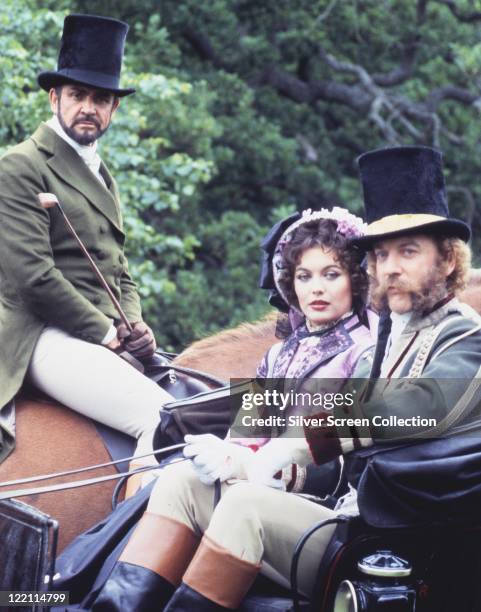 Sean Connery, British actor, on horseback, with Lesley-Anne Down, British actress, and Donald Sutherland, Canadian actor, riding in a carriage, all...