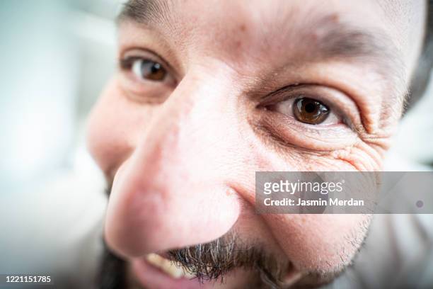 extreme close up portrait of funny laughing man - fischaugen objektiv stock-fotos und bilder