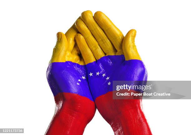 cupped hands on white background with venezuelan flag - venezuela flag stock pictures, royalty-free photos & images