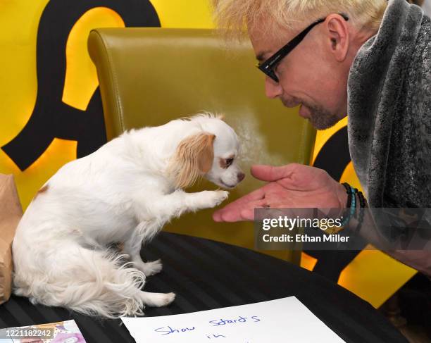 Magician/comedian Murray SawChuck plays with his dog Smudge before teaching magic tricks on Facebook Live from his home with creative...