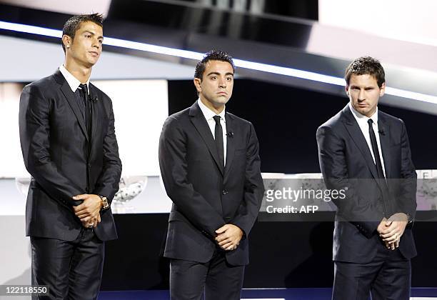 Real Madrid's Portuguese forward Cristiano Ronaldo, Barcelona's Spanish midfielder Xavier Hernandez and Argentinian forward Lionel Messi wait for the...