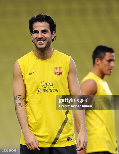 Cesc Fabregas of FC Barcelona smiles during a training session on the eve of the UEFA Super Cup final match between FC Barcelona and FC Porto at the...