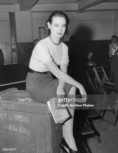American socialite, fashion designer, actress, writer and artist Gloria Vanderbilt, January 1955. She is holding a copy of the Pulitzer Prize-winning...