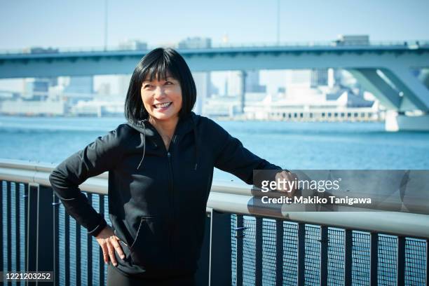 portrait of mature sportswoman outdoors - 50 year old japanese woman stock pictures, royalty-free photos & images