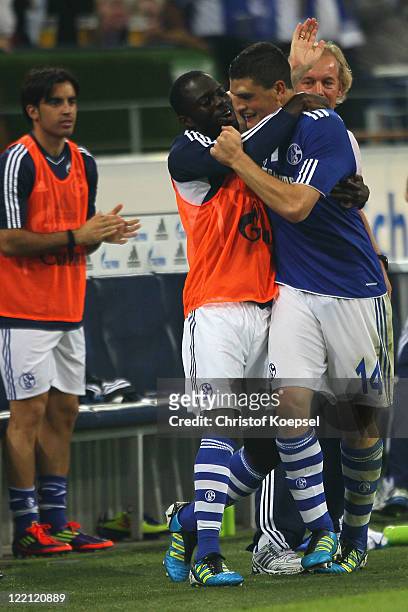 Kyriakos Papadopoulos celebrates the forth goal with Hans Sarpei during the UEFA Europa League play-off second leg match between FC Schalke and HJK...