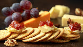stack of crackers with apple chutney and other snacks