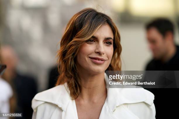 Elisabetta Canalis wears earrings, a white jacket, outside Alberta Ferretti, during Milan Fashion Week Fall/Winter 2020-2021, on February 19, 2020 in...