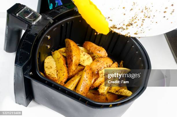 air fryer grill potato at home isolated on white. - house warm heating oil stockfoto's en -beelden