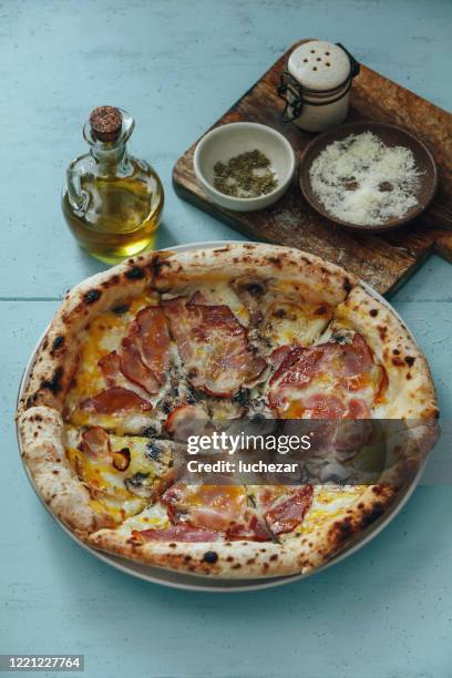 italian pizza with ham and mushroom - grated mozzarella stock pictures, royalty-free photos & images