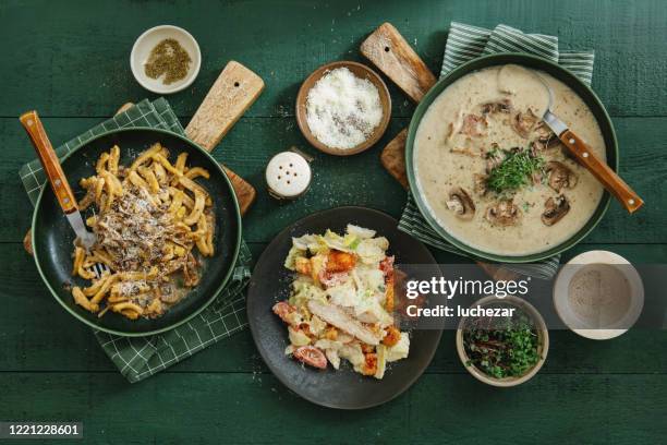 italian dishes. cream of wild mushroom soup and caserecce with wild mushrooms and caesar salad - comfort food stock pictures, royalty-free photos & images