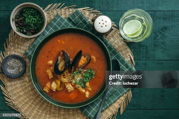 cacciucco – tuscan seafood stew on dark green background. - clam seafood stock pictures, royalty-free photos & images