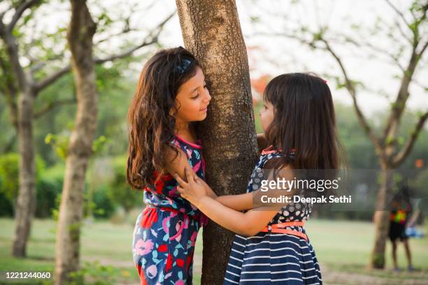 kids in playground stock photo - sibling stock pictures, royalty-free photos & images