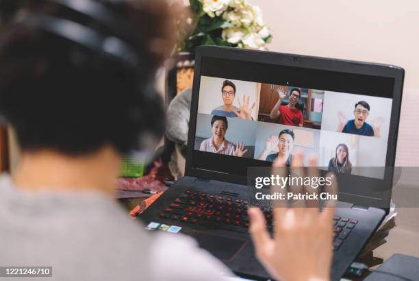 asian chinese male having online video conference with friends - digitaal display stock pictures, royalty-free photos & images