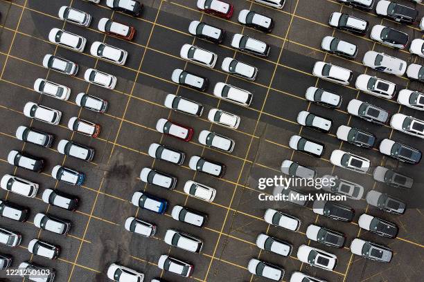 An aerial view from a drone shows new vehicles parked in a lot near the Port of Baltimore, on April 26, 2020 in Baltimore, Maryland. Vehicle sales in...
