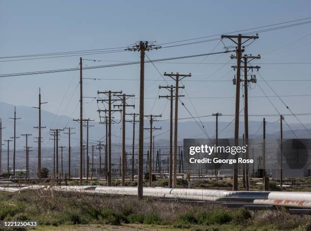 Oil pipelines, pumping rigs, and electrical transmission lines dot the landscape along California's "Petroleum Highway" running along the...