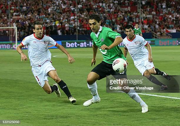 Fernando Navarro of Sevilla, Mohammed Abdellaoue of Hannover and Alvaro Negredo of Sevilla battle for the ball during the UEFA Europa League Play-Off...