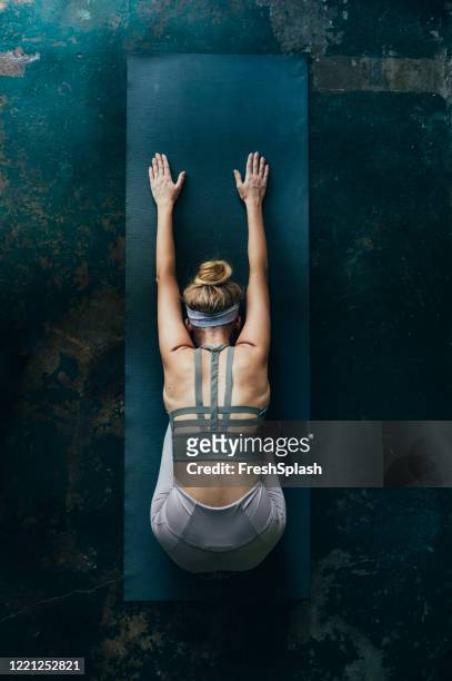 self care rituals: blonde woman doing yoga at home, an overhead view - yoga stock pictures, royalty-free photos & images