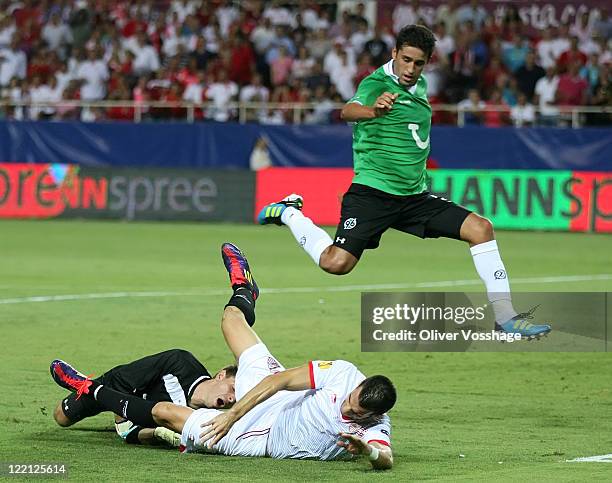 Keeper Ron-Robert Zieler of Hannover, Alvaro Negredo of Sevilla and Mohammed Abdellaoue battle for the ball during the UEFA Europa League Play-Off...