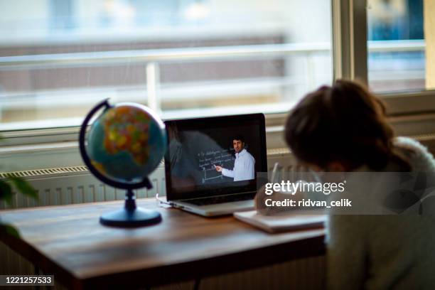 coronavirus outbreak. lockdown and school closures. schoolgirl watching online education class - school lockdown stock pictures, royalty-free photos & images
