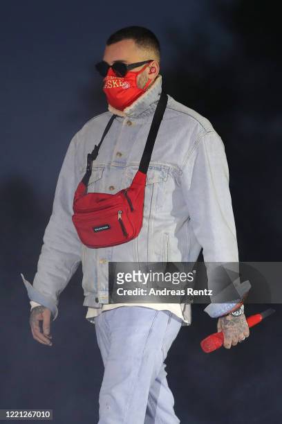 German rapper Sido wears a protective face mask upon his arrival on stage at the Georg Schutz drive-in cinema during the coronavirus crisis on April...