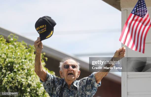 Army World War II veteran Lt. Colonel Sam Sachs, who turned 105 today, waves an American flag at his drive-by birthday party amid the coronavirus...