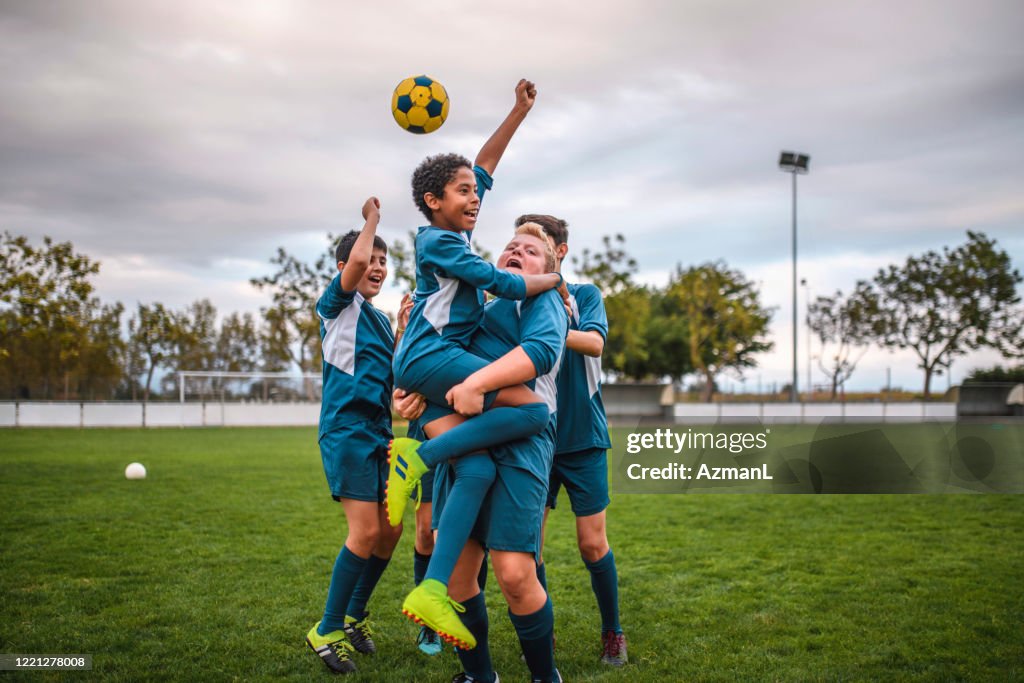 Blue Jersey Boy Footballers Cheering and Celebrating