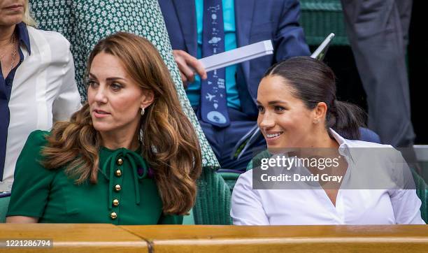 Catherine, Duchess of Cambridge sits with Meghan, Duchess of Sussex in the Royal Box on Centre Court ahead of the Ladies Singles Final between Simona...