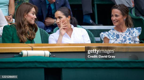 Catherine, Duchess of Cambridge sits with Meghan, Duchess of Sussex, and Pippa Middleton in the Royal Box on Centre Court ahead of the Ladies Singles...