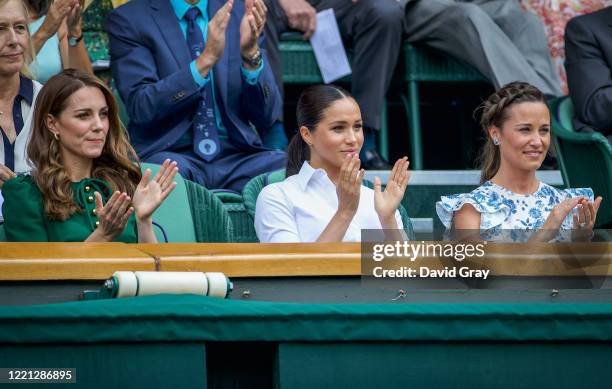 Catherine, Duchess of Cambridge sits with Meghan, Duchess of Sussex, and Pippa Middleton in the Royal Box on Centre Court ahead of the Ladies Singles...