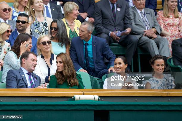 Catherine, Duchess of Cambridge sits with Meghan, Duchess of Sussex, and Pippa Middleton in the Royal Box on Centre Court ahead of the Ladies Singles...