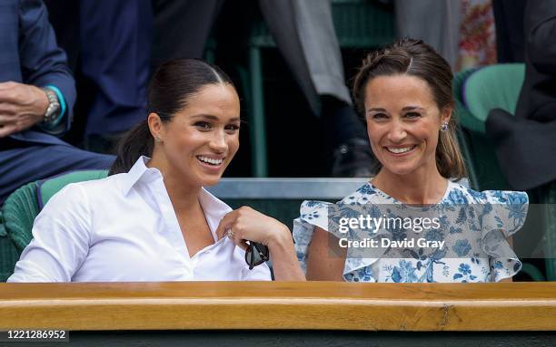 Meghan, Duchess of Sussex, sits with Pippa Middleton in the Royal Box on Centre Court ahead of the Ladies Singles Final between Simona Halep of...