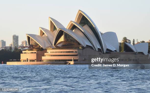 Sydney Harbour taking in the Harbour Bridge, Opera House and ferries at sunrise during the COVID-19 pandemic on April 20, 2020 in Sydney, Australia.