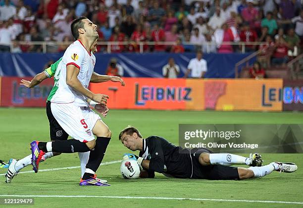 Hannover 96 Keeper Ron-Robert Zieler makes a save as Sevilla's Alvaro Negredo Sanchez closes in during the UEFA Europa League Play-Off second leg...