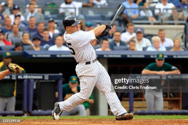 Russell Martin of the New York Yankees hits a grand slam home run in the 6th inning against the Oakland Athletics on August 25, 2011 at Yankee...