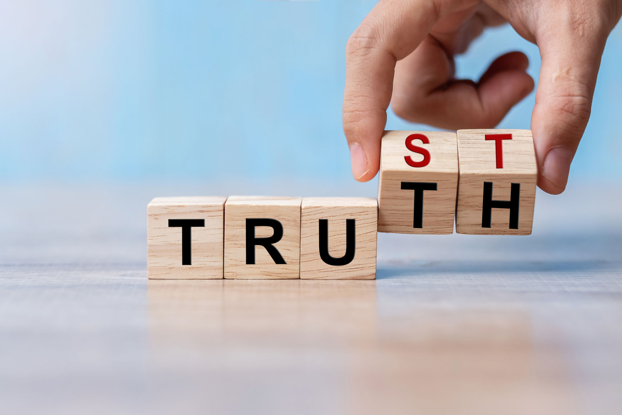 Businessman hand change wooden cube block with TRUST and TRUTH business word on table background. Trustworthy, Truth, beliefs and agreement concept Businessman hand change wooden cube block with TRUST and TRUTH business word on table background. Trustworthy, Truth, beliefs and agreement concept