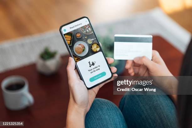 ordering food online at home with smartphone and credit card - order takeout stock pictures, royalty-free photos & images