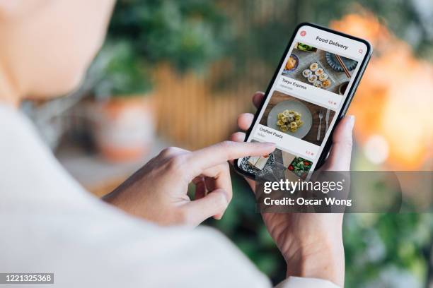 ordering food online at home with smartphone - ordering food stock pictures, royalty-free photos & images