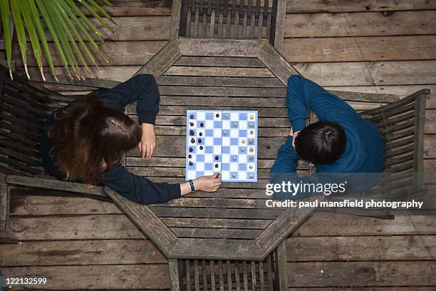 children playing chess - chess board overhead stock pictures, royalty-free photos & images