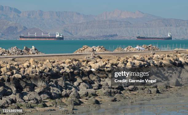 large cargo and tanker ships at shahid rajai port from qeshm island pier, persian gulf, iran - stretto foto e immagini stock