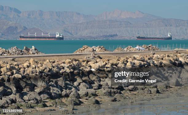 large cargo and tanker ships at shahid rajai port from qeshm island pier, persian gulf, iran - bandar abbas stock pictures, royalty-free photos & images